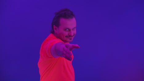 Crazy-man-dancing-in-the-neon-light-of-the-ridiculous-dance.-Funny-man-on-a-colored-blue-background